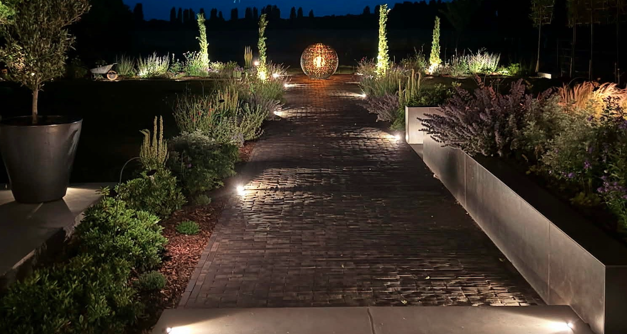 Illuminated garden path with cobblestone paving and garden lighting — garden construction by Will Draper, Norfolk