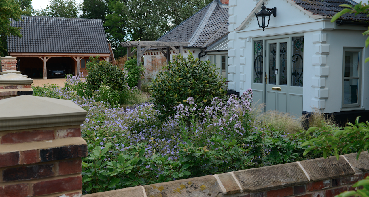 Contemporary garden with raised beds and standard trees — garden design by Will Draper, Norfolk